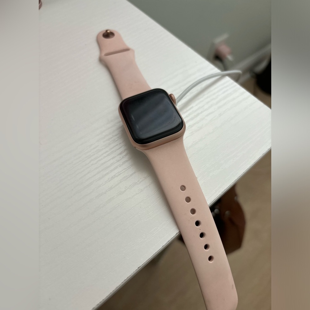 Apple Watch Series 4 in perfect condition. Includes baby pink band & charger!
